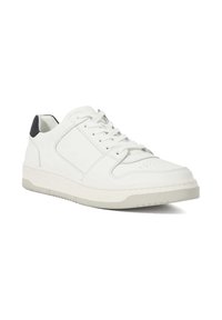 White leather sneaker with a low profile, textured surface, round toe, and gray rubber sole. Features a dark accent on the heel.