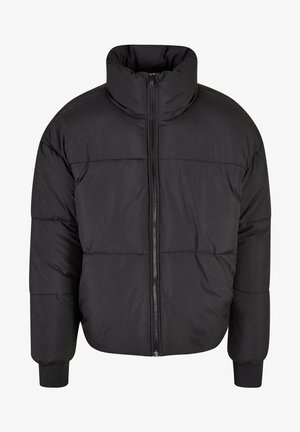 Svart puffjacka med hög krage, hel dragkedja fram och quiltat mönster. Ärmarna är elastiska för en snug passform.