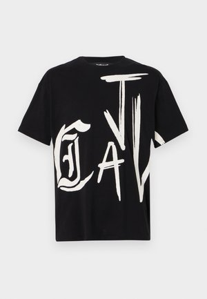 Crna kratka majica s kratkim rukavima s odvažnim bijelim grafičkim dizajnom koji prikazuje velike, stilizirane natpise na prednjoj strani. Pamuk, okrugli izrez.