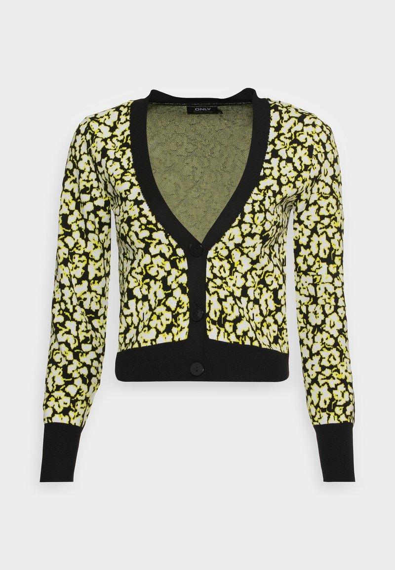 Cardigan à motifs avec un col en V profond, des manches longues et une bordure noire. Le tissu présente un motif floral jaune sur un fond noir.