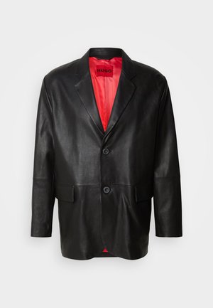 Black leather blazer with notched lapels, two front buttons, and two side pockets. Interior features a bright red lining.