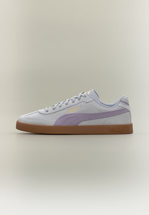 Lysegrå Puma-sneakers med lavendelfarvet stribe, gult Puma-logo, brun sål og snøredesign på neutral baggrund.