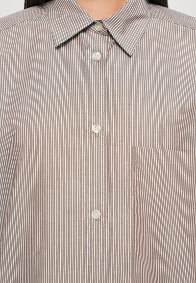 Brown and white striped shirt with a buttoned collar, featuring a single chest pocket and white plastic buttons. Soft fabric texture.
