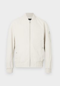 Casaco bomber cinza claro com fecho zipper à frente, gola e punhos canelados, dois bolsos laterais e um bolso com fecho na manga esquerda. Textura suave.