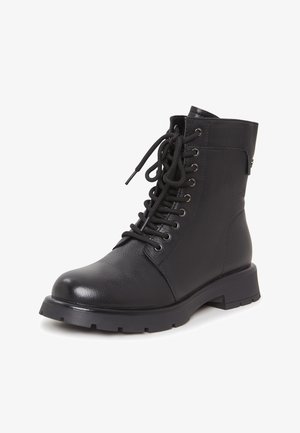 Black leather ankle boot with a round toe, eyelet lace-up front, textured finish, and a chunky rubber sole with traction grooves.