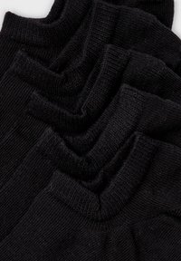 Zwarte katoenen sokken gestapeld met geribbelde boorden, met een gladde textuur en een consistente vorm. Alle items hebben dezelfde kleur en stijl.