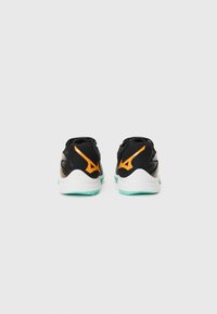 Black athletic shoes with orange accents, textured mesh upper, cushioned sole, and turquoise rubber outsole. Notable logo detail on heel.