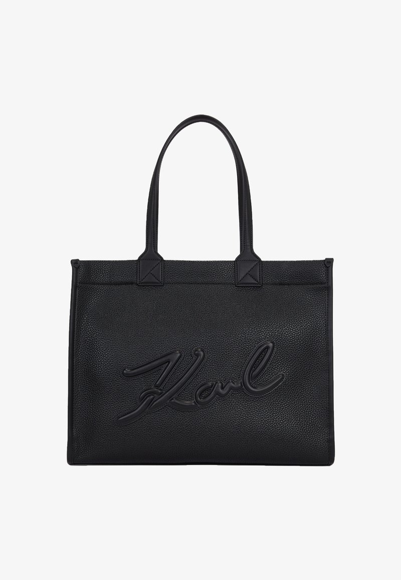 Sac à main rectangulaire en cuir noir avec deux poignées et logo en écriture cursive en relief "Karl" au centre avant.