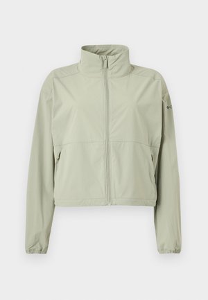 Lys grønn lettvektsjakke med høy krage, frontglidelås, lange ermer med elastiske mansjetter og glidelåslommer på siden.