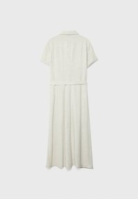 Robe en lin beige clair avec col, manches courtes, taille ceinturée et jupe longue, présentant une texture lisse et un design simple.