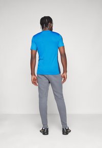 Nike Performance TOTTENHAM  TECH FLEECE JOGGER PANTS - Vereinsmannschaften - dark grey/white
