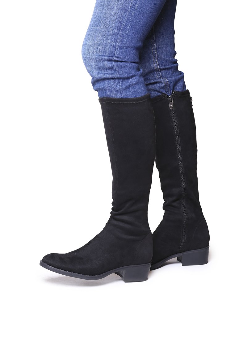 Botas altas de ante negras con un tacón bajo, cierre de cremallera en el lateral y una textura suave. Diseñadas con una punta afilada y un eje ajustado.