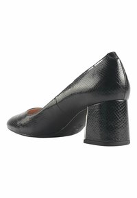 Black high-heeled shoe with a textured finish, rounded toe, and a square block heel featuring a metallic accent. Smooth interior lining.
