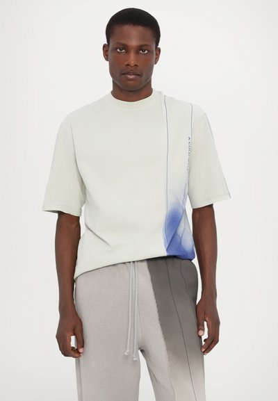 Light grey cotton t-shirt with a blue gradient design on the left side, featuring a crew neckline and short sleeves.