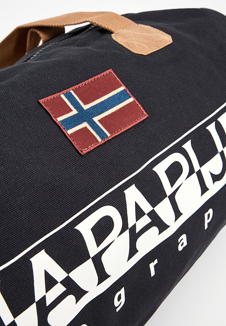 Donker stoffen reistas met bruine handgreep, Noorse vlag patch en groot wit "Napapijri" logo.