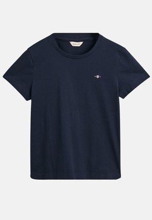T-shirt en coton bleu marine avec un col ras du cou classique, des manches courtes et un petit logo brodé sur la poitrine. Texture douce, design simple.