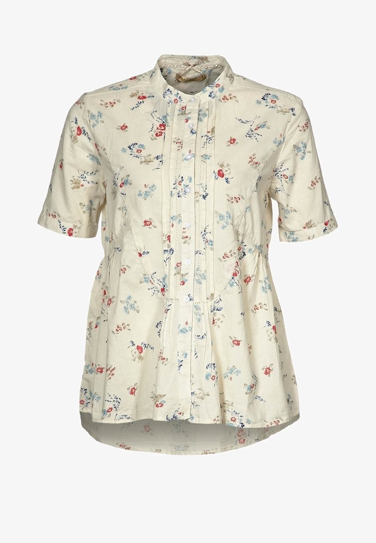 Chemisier crème à manches courtes avec petit imprimé floral rouge, bleu et beige, devant boutonné et légère évasement à la taille.