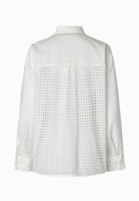 White long-sleeve shirt with a textured fabric, featuring a grid pattern, button cuffs, and a back yoke for added structure.