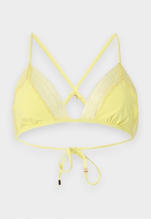 Żółty biustonosz typu bralette w kształcie trójkąta z koronkową lamówką, regulowanymi skrzyżowanymi ramiączkami i wiązaniem z tyłu, przedstawiony na białym tle.