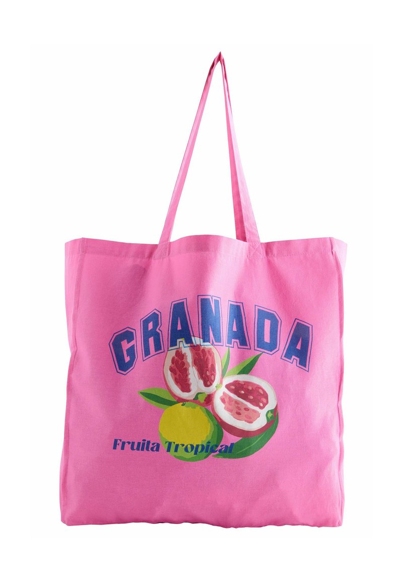 Borsa in cotone rosa con manici lunghi, che presenta un design grafico di melagrane e un limone, etichettata "GRANADA" e "Fruta Tropical."