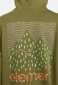 Olive green hoodie featuring a mountain graphic in light blue with wavy lines, and orange text at the bottom, made from soft fabric.