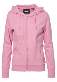 Pink zip-up hoodie made of cotton blend, featuring a drawstring hood, front pockets, and “Superdry” logo in colorful text on the sleeve.