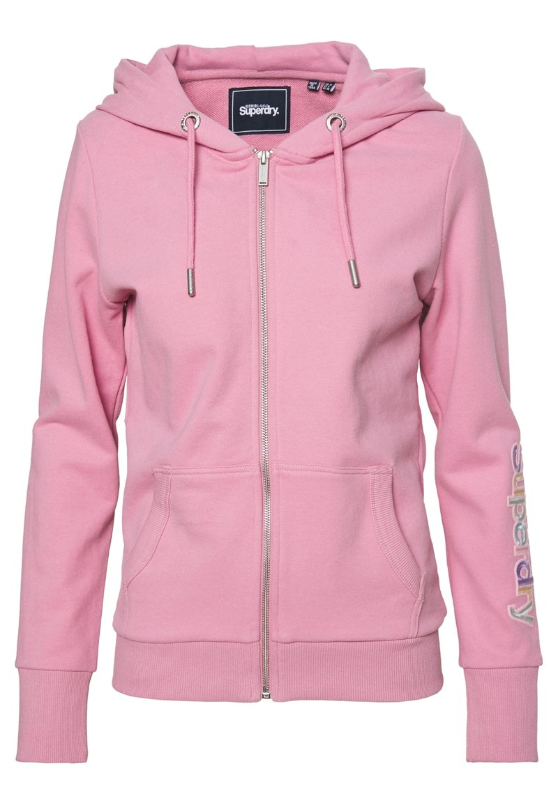 Pink zip-up hoodie made of cotton blend, featuring a drawstring hood, front pockets, and “Superdry” logo in colorful text on the sleeve.