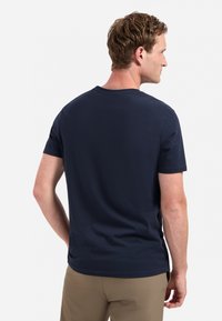 Marineblauwe katoenen t-shirt met een ronde hals, korte mouwen en een gladde textuur, gezien vanuit de achterkant, met een ontspannen pasvorm.