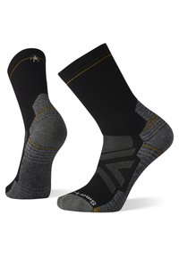 Chaussettes noires et grises avec un design texturé, dotées d'un talon et d'un orteil renforcés, de coutures en accent doré et d'un logo Smartwool sur la semelle.