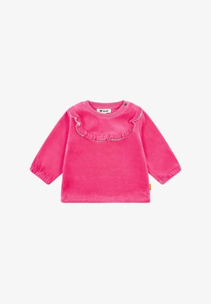 Haut en velours rose à manches longues avec un col à volants et des poignets élastiqués. Le design est simple, en couleur unie sans motifs.