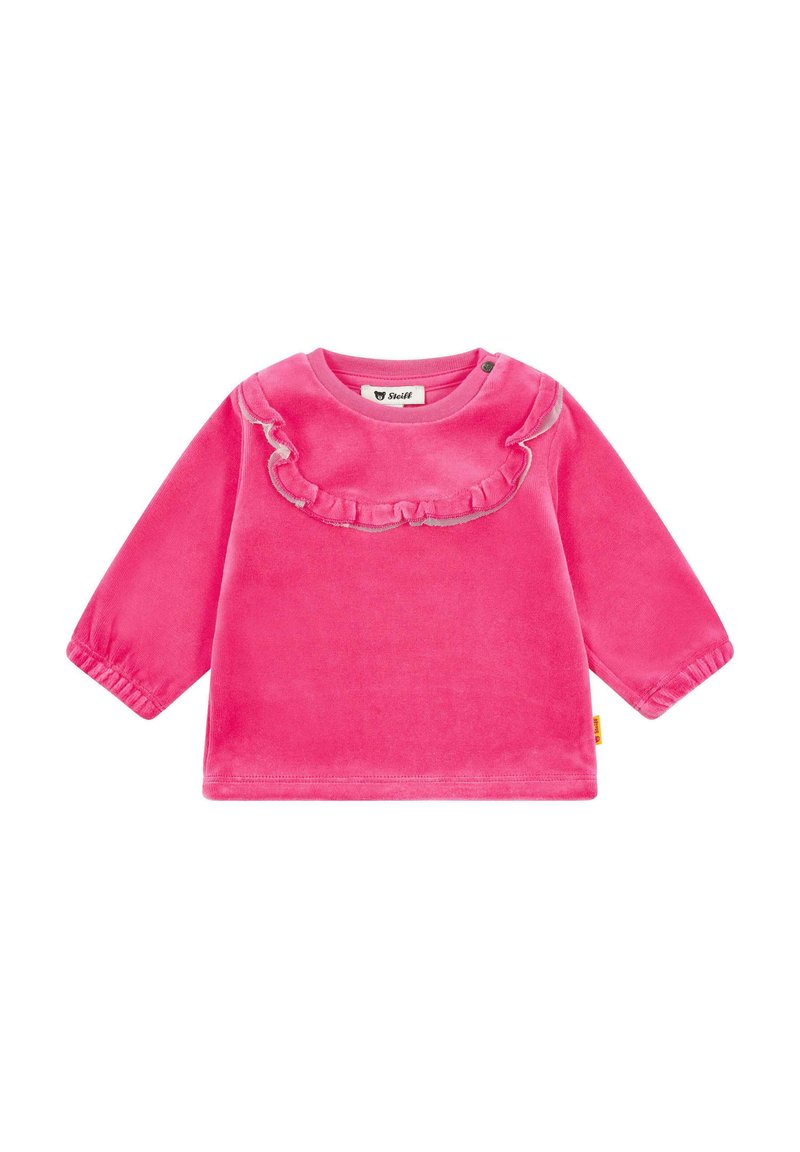 Blusa larga de terciopelo rosa de manga larga con un escote con volantes y puños elásticos. El diseño tiene un color sólido y simple sin patrones.