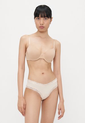 Beige rintaliivi, jossa on sileät kupit ja säädettävät olkaimet, yhdistettynä samansävyisiin alushousuihin, joissa on pitsireunus ja pehmeä kangastunne.