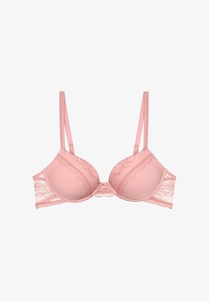 Soutien-gorge rose clair à armatures avec bordure en dentelle, bretelles fines réglables et bonnets moulés sur fond blanc.
