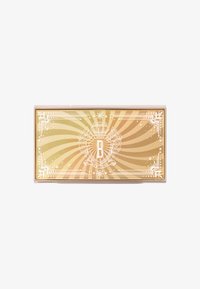 Gylden rektangulær kasse med en solstråle design, hvidt udsmykket kant og centralt emblem med bogstavet 'B' og "NEW YORK" nedenfor.