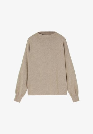 Bežs krekls ar mīkstas auduma izskatu; tam ir apaļš kakls un garas piedurknes ar zaļu akcenta joslu gar sāniem.