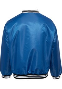 Blue satin bomber jacket with ribbed black and white collar and cuffs. Features a loose fit and elastic waistband, smooth texture.