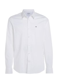 Camisa blanca de manga larga, con botones, hecha de algodón suave, con cuello tipo punta y pequeño logo negro "CK" en el lado izquierdo del pecho.
