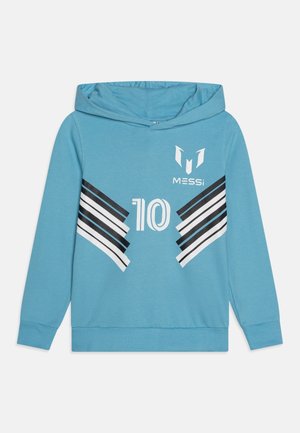 Sudadera azul con rayas en zigzag en blanco y negro, número 10 centrado y logo de Messi en la parte superior izquierda del pecho.