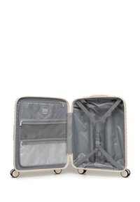 Twarda walizka w jasno beżowym kolorze, wyposażona w szare wnętrze z przegródkami na zamek i paskami krzyżowymi. Gładkie, wielokierunkowe kółka.