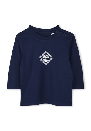 Marineblauwe lange mouw shirt van katoen met een ronde hals en drukknoopdetail. Bevat een wit logo in het midden. Gladde textuur.