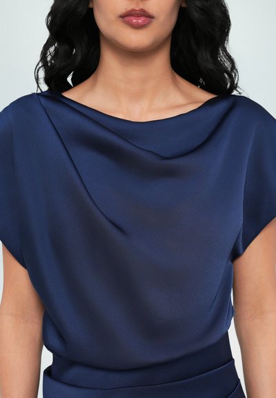 Navy blue satin top with wide, draped neckline and short sleeves. Smooth texture with subtle sheen, fitted at the waist.