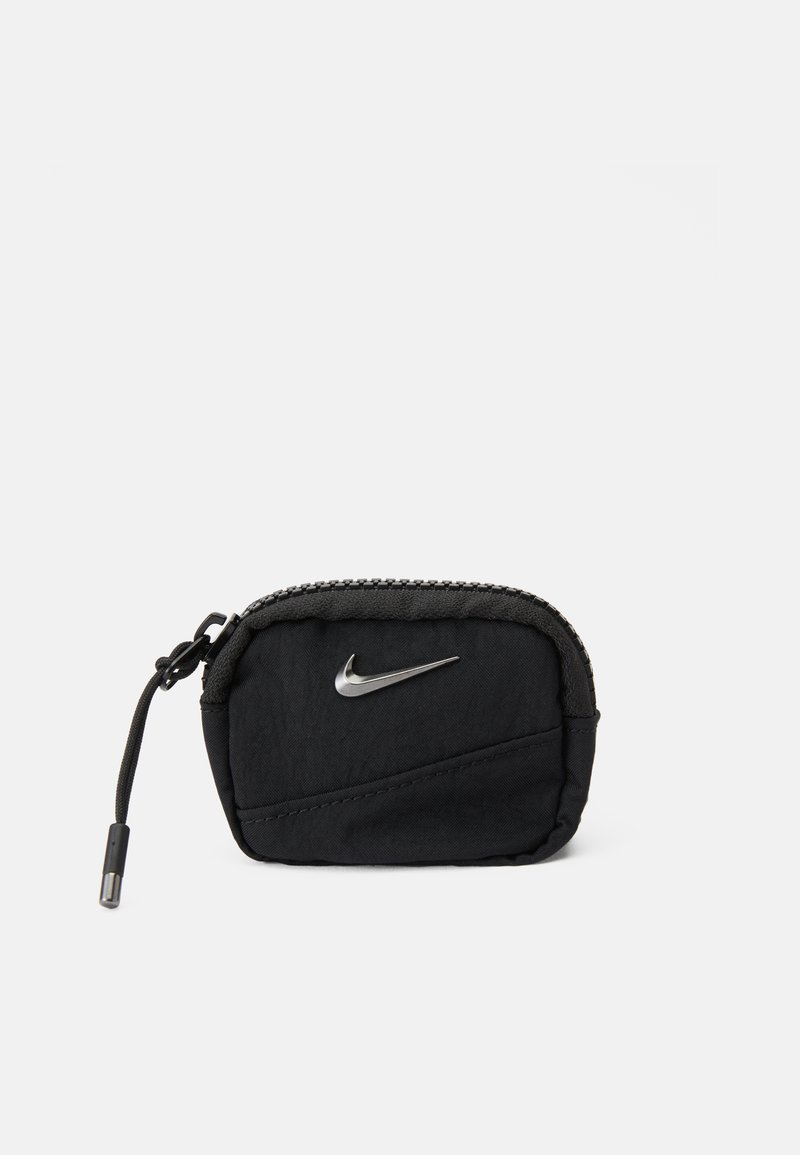 Fekete szövetből készült, cipzáros tasak, ezüst Nike logóval, texturált felülettel és tartós zsinóros cipzárahúzóval. Kompakt, téglalap alakú.
