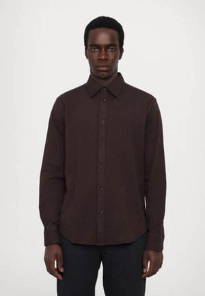Long-sleeve brown shirt in a textured fabric, featuring a button-down collar, front buttons, and a curved hem.