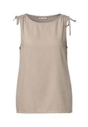 Beige toppi ilman hihoja, jossa on teksturoitu kangas, pyöreä kaula-aukko ja säädettävät solmukeasusteet olkapäillä.