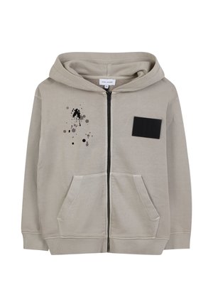 Helle beige Zip-Up-Hoodie aus Baumwollmischung, mit einer Fronttasche, schwarzem Stoffaufnäher und einem abstrakten Design aus schwarzem und grauem Farbspritzern.