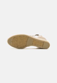 Espadrille shoe with a woven texture, beige color, and rubber sole. Features a jute midsole and a small metallic buckle accent. Size 37.