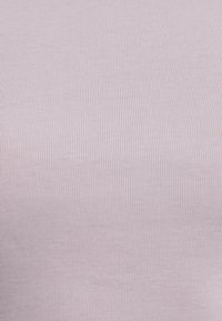 Light purple ribbed fabric featuring a soft texture with vertical stripes. Stretchy and smooth with a consistent pattern throughout.