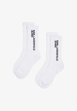 Witte katoenen sokken met ribbeltextuur en het zwart "KARL LAGERFELD JEANS" logo dat verticaal aan de zijkant is gedrukt.