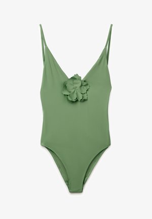 Grüner Badeanzug mit dünnen Schulterträgern und einer großen dekorativen Blume in der Mitte der Brust.