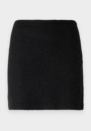 Mustast villast mini-seelikust tekstureeritud pinna, istuv siluett ja soonikkoes vöökoht. Ei ole lisaseadmeid ega mustreid.